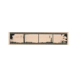 May include: A black and white film strip with three frames. The frames are empty and have a faded, vintage look.