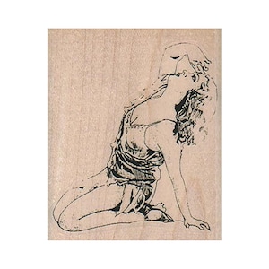 May include: A black and white illustration of a woman in a flowing dress, kneeling with her head tilted back and one arm raised. The image is a stamp on a light wood block.