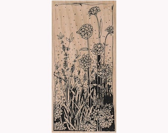 May include: A wood-mounted rubber stamp with a black and white illustration of a field of flowers. The flowers are stylized and have a whimsical feel.