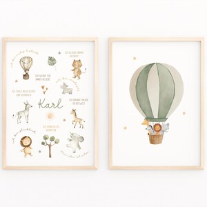 May include: Two framed watercolor prints. One features a hot air balloon with animals in a basket. The other has illustrations of animals, a hot air balloon, and the name "Karl". The prints have a light wood frame.