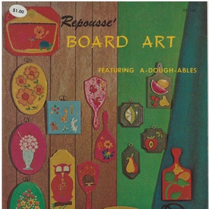 May include: A vintage craft book cover featuring a variety of colorful, hand-painted wooden items, including a mirror, a bird, a pear, a basket, and a purse. The book title is "Repousse' Board Art Featuring A-Dough-Ables".