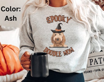 May include: A gray sweatshirt with the text "Spooky Doodle Mom" and a doodle dog wearing a witch hat.