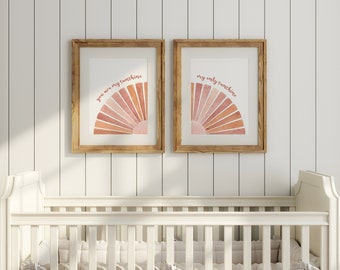 May include: Two framed prints with watercolor sunbursts and the text "you are my sunshine" and "my only sunshine" in pink lettering.