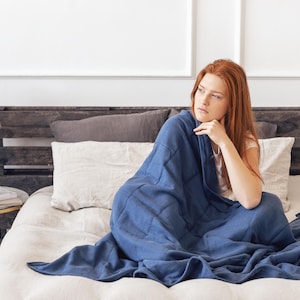 Women are covered by a weighted blanket blue color