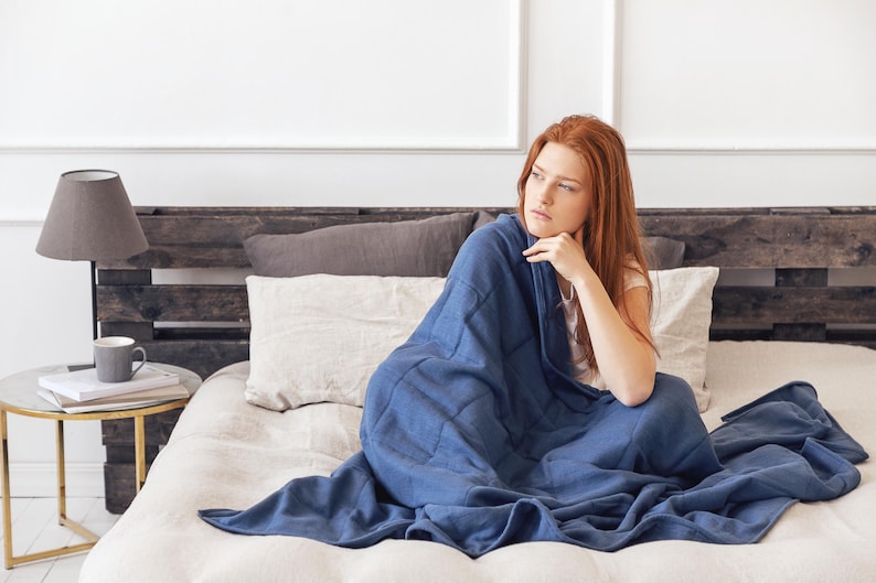 Women are covered by a weighted blanket blue color