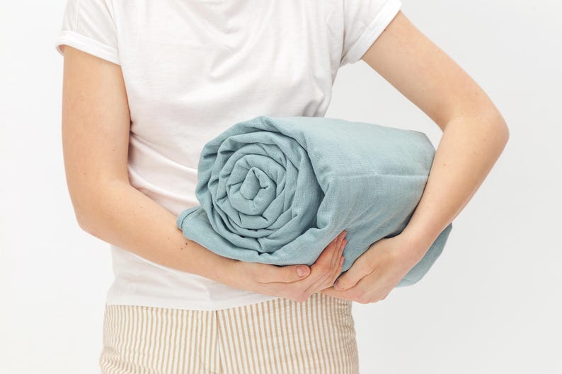 Women holding blue color weighted blanket