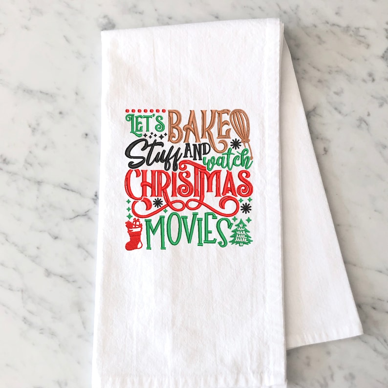 Pu&ograve; includere: Asciugamano da cucina bianco con ricamo rosso, verde e marrone che dice "Let's Bake Stuff and Watch Christmas Movies".