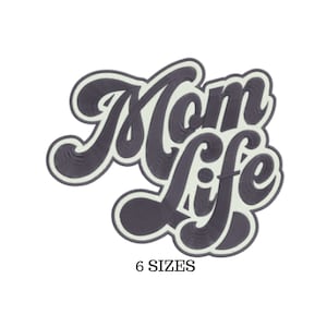 May include: A dark gray embroidered patch with the words "Mom Life" in a stylized font. The text has a light gray outline and is set against a white background. The phrase "6 SIZES" is printed below.