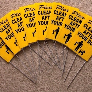 May include: A set of nine yellow signs with black text and a black silhouette of a person picking up dog waste. The signs read "Please Clean Up After Your Dog".