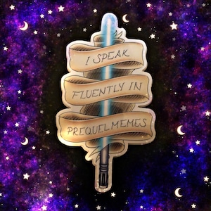 May include: A sticker with a lightsaber design and three banners. The banners say "I SPEAK FLUENTLY IN PREQUEL MEMES". The lightsaber has a blue blade and a silver hilt. The background is a starry night sky with crescent moons.
