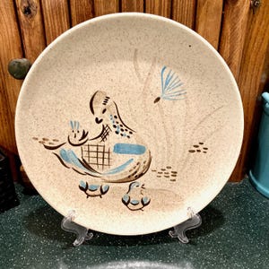 May include: A rustic wooden sign with the text "Welcome to our home" in white lettering. The sign features a distressed finish and a simple, inviting design, perfect for a front porch or entryway.