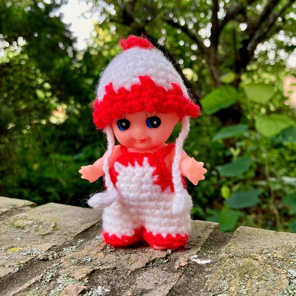 Kewpie Doll in Crocheted Outfit and Hat, Plastic or Rubber Toy Figurine, White and Red Overalls, Beanie with Ties, 4"