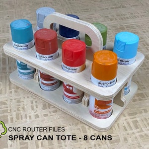May include: A wooden spray paint can tote with a handle, holding eight spray paint cans in various colors, including blue, red, orange, and green. The tote is made of plywood and has a CNC router file design.