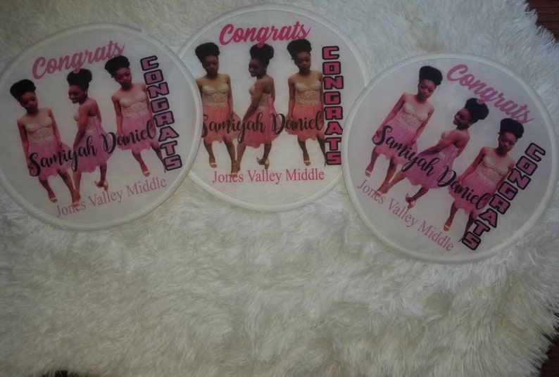 May include: Three white round patches with pink trim and the text "Congrats" in black. Each patch features a photo of three girls in pink dresses with the text "Samiyah Daniel" and "Jones Valley Middle" in black.