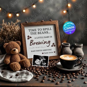 Pode incluir: Um anúncio de gravidez com uma moldura de madeira exibindo o texto "Time to Spill the Beans... A Little Baby is Brewing". O anúncio inclui uma ultrassonografia, um ursinho de pelúcia, botinhas de bebê e uma xícara de café. O anúncio é cercado por grãos de café.