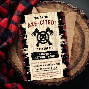 May include: A rectangular birthday invitation card featuring a red and black buffalo plaid border, a wood grain background, and two crossed axes. The text reads: WE'RE SO AXE-CITED! TO CELEBRATE LANDON'S 40TH BIRTHDAY! SATURDAY AUGUST 15TH 2PM AXE THROWING PLACE.