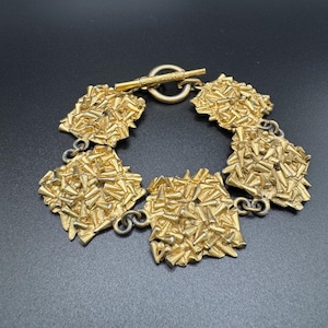 Vintage Biche de Bère bracelet in hammered gold metal - French designer jewelry from the 80s