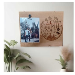 May include: A wooden photo frame with a laser-engraved design featuring the Hogwarts castle and the text "After all this time, Always". The frame has a photo of a couple in front of the Hogwarts castle.