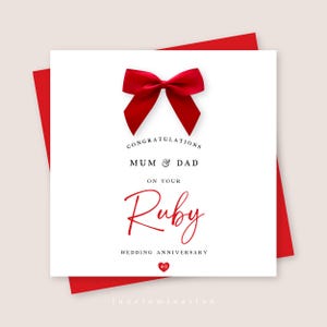 May include: A square white greeting card featuring a bright red satin bow at the top. The text reads: CONGRATULATIONS MUM & DAD ON YOUR Ruby WEDDING ANNIVERSARY with a small red heart icon containing the number 40 at the bottom centre.