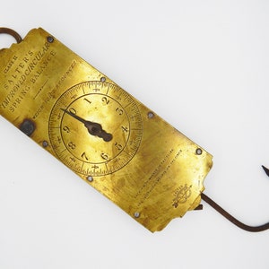 May include: A brass Salter's Improved Circular Spring Balance scale with a dial that reads up to 5 ounces. The scale has a hook on each end and is marked "Class II".