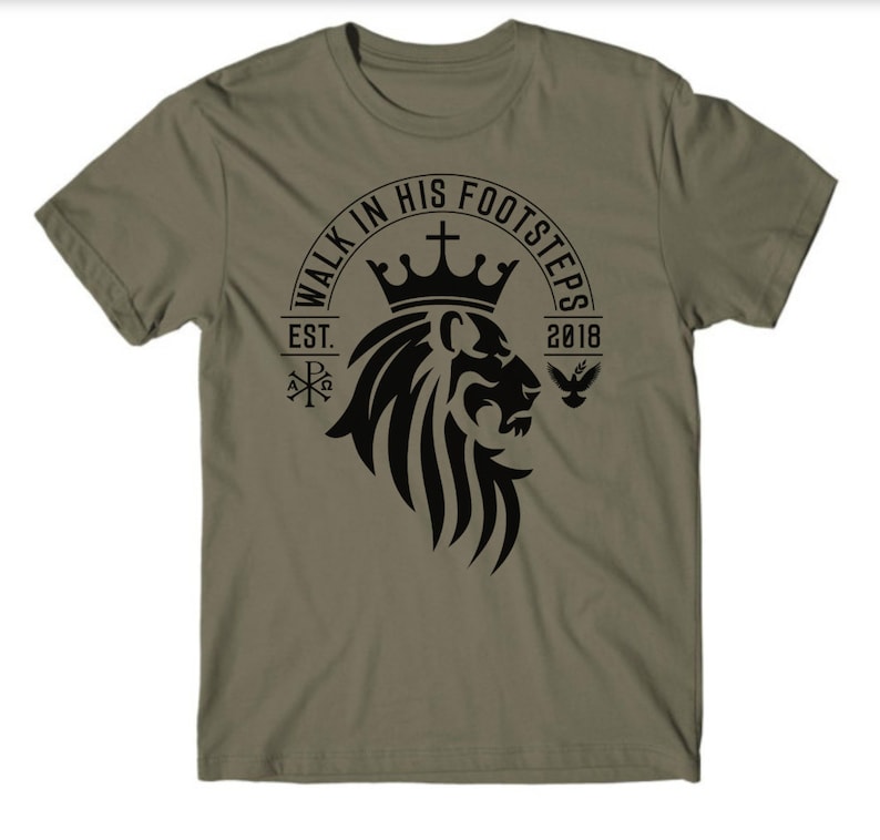 May include: A green t-shirt with a black lion head graphic. The graphic includes a crown, a cross, and the text "Walk in His Footsteps Est. 2018".