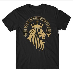 May include: Black t-shirt with a gold lion graphic and the text "Walk in His Footsteps Est. 2018".