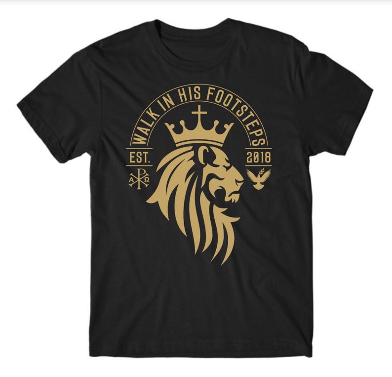 May include: Black t-shirt with a gold lion graphic and the text "Walk in His Footsteps Est. 2018".