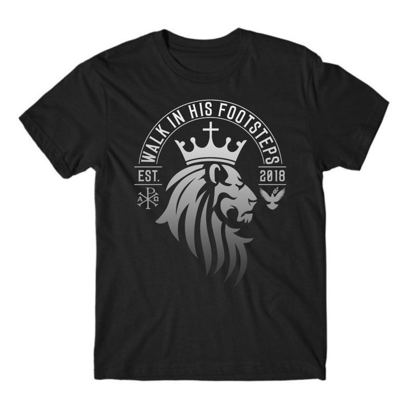 May include: Black t-shirt with a silver graphic of a lion wearing a crown. The graphic includes the text "Walk in His Footsteps" and "Est. 2018".