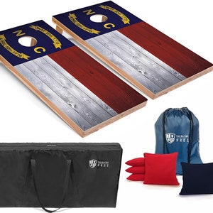 May include: A North Carolina state flag cornhole set with two wooden boards, a carrying bag, and bean bags. The boards are decorated with the North Carolina state flag, which features a blue background with a white star and the words "May 20, 1775" and "April 12, 1776". The bean bags are red and blue.