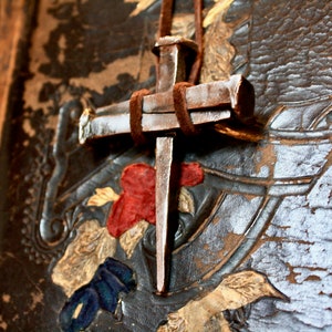 three nails, one cross pendant