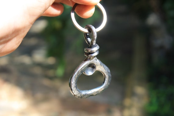 A real blacksmith actually hammered this keychain bottle opener by hand — 199 favorites don't lie, it's the ideal "I actually made this" gift that looks incredible and gets used daily.