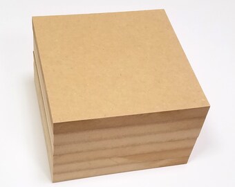 May include: A stack of four brown, rectangular pieces of wood. The wood is smooth and has a light brown color.