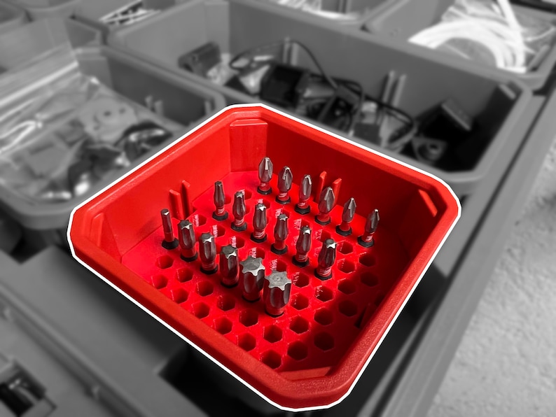 Red Milwaukee PACKOUT low-profile organizer with black 1/4 inch drill bit holder inserts organizing driver bits in custom compartments, 3D printed tool storage system