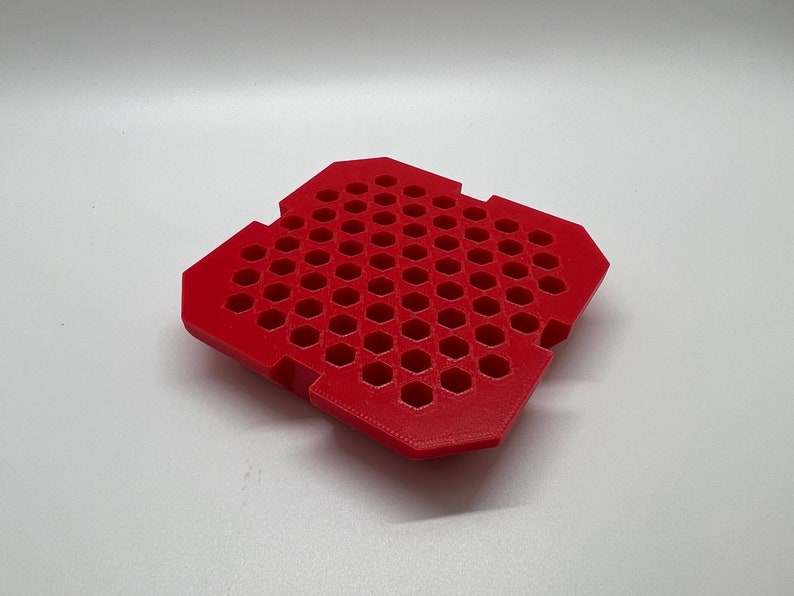 May include: Red plastic tray with a honeycomb pattern. The tray has a square shape and is made of a durable material.