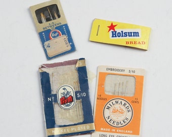 May include: Four packages of needles for sewing and embroidery. The packages are labeled "Cox's", "Holsum Bread", "Prym", and "Milwards Needles".