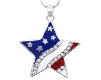 May include: A silver chain necklace with a star-shaped pendant. The star is blue with white stars and a red and white stripe design. The stripe is decorated with clear rhinestones.
