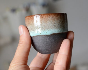 to order SMALL BLACK BROWN espresso cup, 50-100ml/1.7-3,5oz, black outside with turquoise glaze and shiny white glass interior