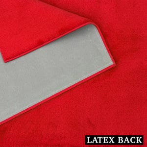 May include: A close-up of a red microfiber towel with a gray backing and a red border. The text "LATEX BACK" is printed in white at the bottom of the image.