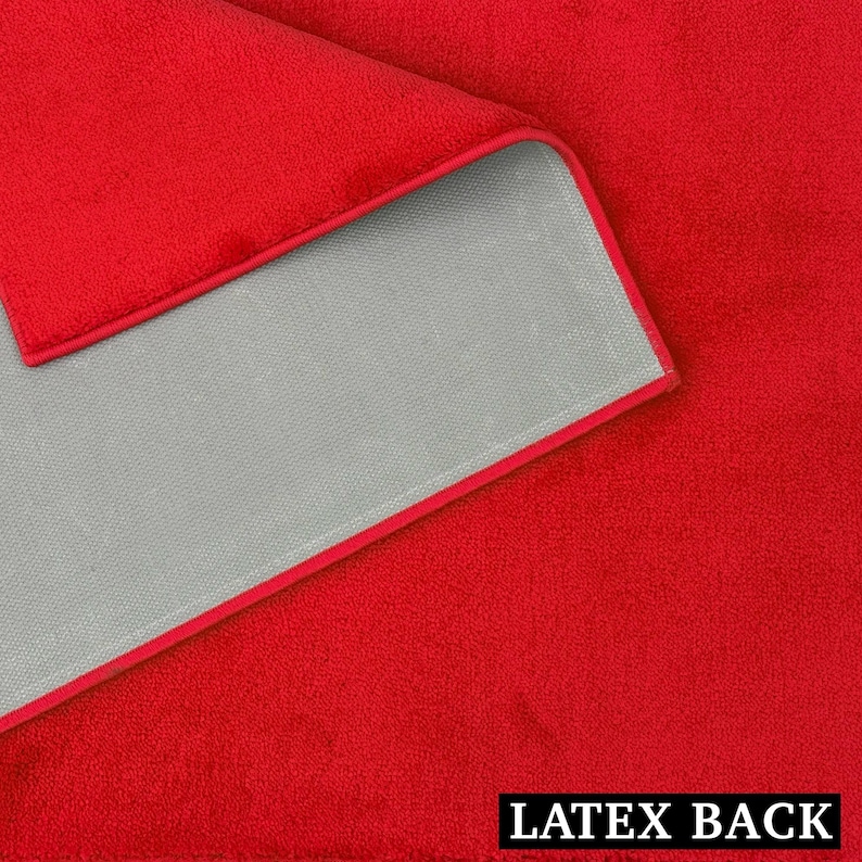 May include: A close-up of a red microfiber towel with a gray backing and a red border. The text "LATEX BACK" is printed in white at the bottom of the image.