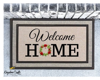 May include: Welcome Home doormat with a wreath design in the "O" of the word "HOME". The wreath is made of green leaves and red flowers. The doormat is brown and has a black border.