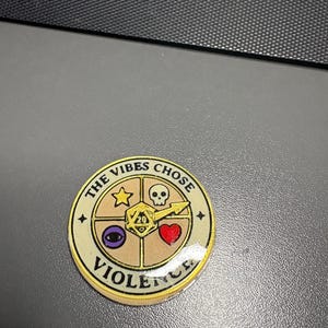 May include: A white ceramic mug with a black handle and the text "But First, Coffee" in a bold, black font. The mug is set against a neutral background, highlighting its simple design.