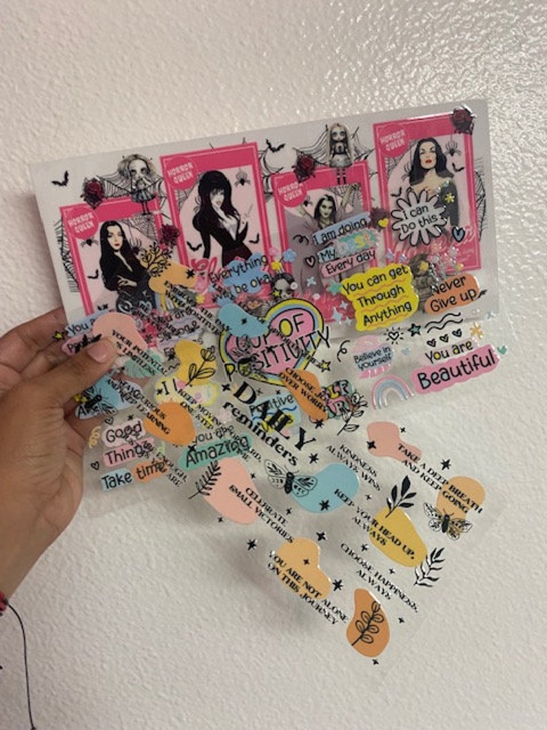 May include: A collection of colorful stickers with positive affirmations and inspirational quotes. The stickers feature a variety of designs, including butterflies, stars, and flowers. The text on the stickers includes phrases like "You are beautiful", "Take a deep breath", and "Keep your head up".