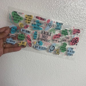 May include: Colorful stickers with positive affirmations for teachers, including "I am enough", "I am a problem solver", "I am brave", "I am kind to my mind", "I will breathe", "I am confident in my teaching abilities", "My work ethic is strong", "I am proud of myself and my work", "I love what I do", "I can learn and grow with each challenge", "It's okay if I can't do it all", "I am an active listener", "I am resilient", "Teacher Daily Affirmations".