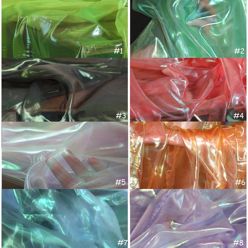 Op de afbeelding: Acht stofstalen van iriserende, doorschijnende stof in verschillende kleuren, waaronder groen, zwart, roze, wit, oranje, paars en blauw. De stof is doorschijnend en heeft een glinsterend effect.