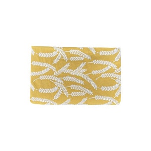 May include: A yellow fabric with a white wheat pattern.