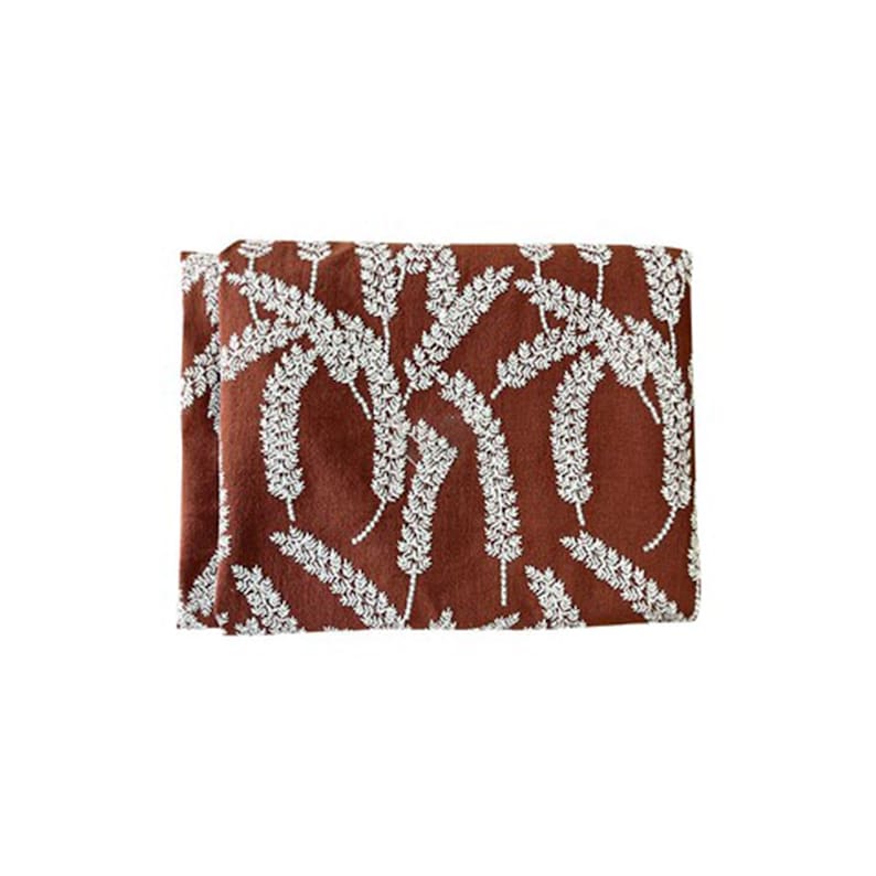May include: A brown fabric with a white floral pattern. The fabric has a subtle texture and a slightly distressed look.