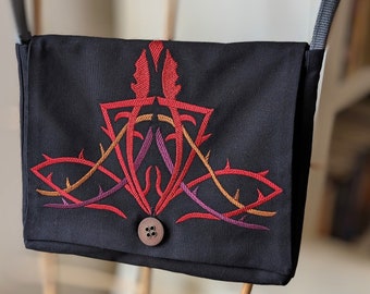 Tablet bag for hanging around the shoulder in black canvas with embroidery in fantasy style