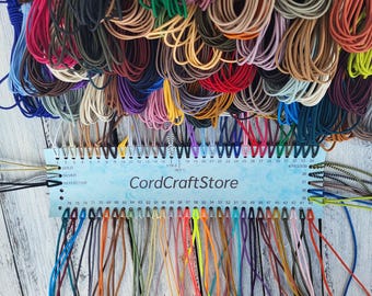 May include: A collection of multi-colored elastic cords organized on a light blue display card labeled CordCraftStore. The card features numbered slots from 1 to 76, with various cords threaded through, showcasing a wide spectrum of hues.