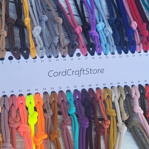 May include: A color chart of 65 different colors of cord, labeled with numbers 1 through 65. The chart is made of white cardstock and has the text "CordCraftStore" printed in black.