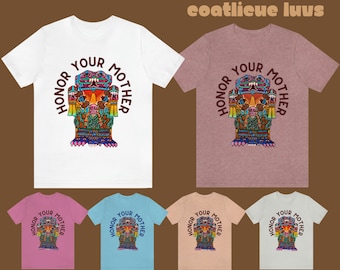 May include: Six t-shirts in different colors with a graphic print of a colorful Aztec-style deity with the text "Honor Your Mother" in a circle around the deity.